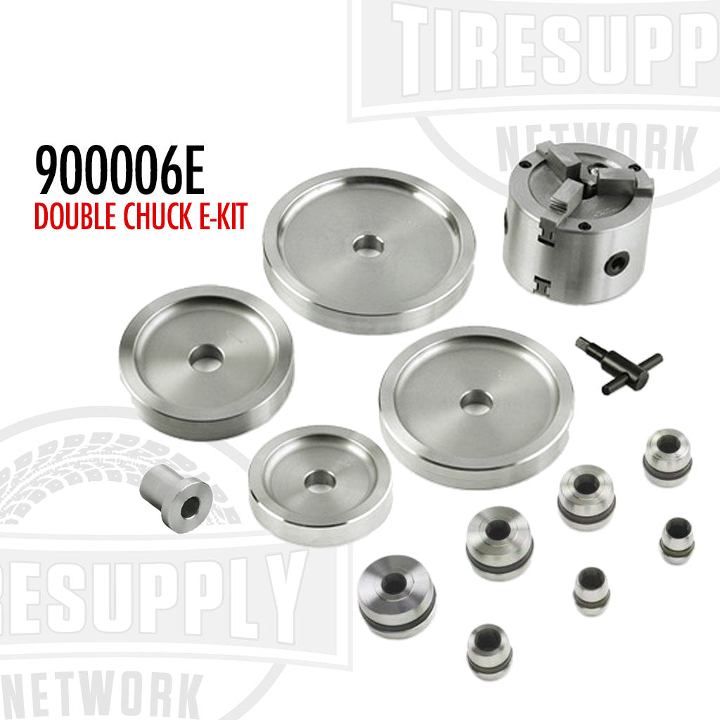An assortment of metal brake lathe adapters and backing plates, labeled as the Double Chuck E-Kit, including various sizes of adapters and a wrench. 900006E