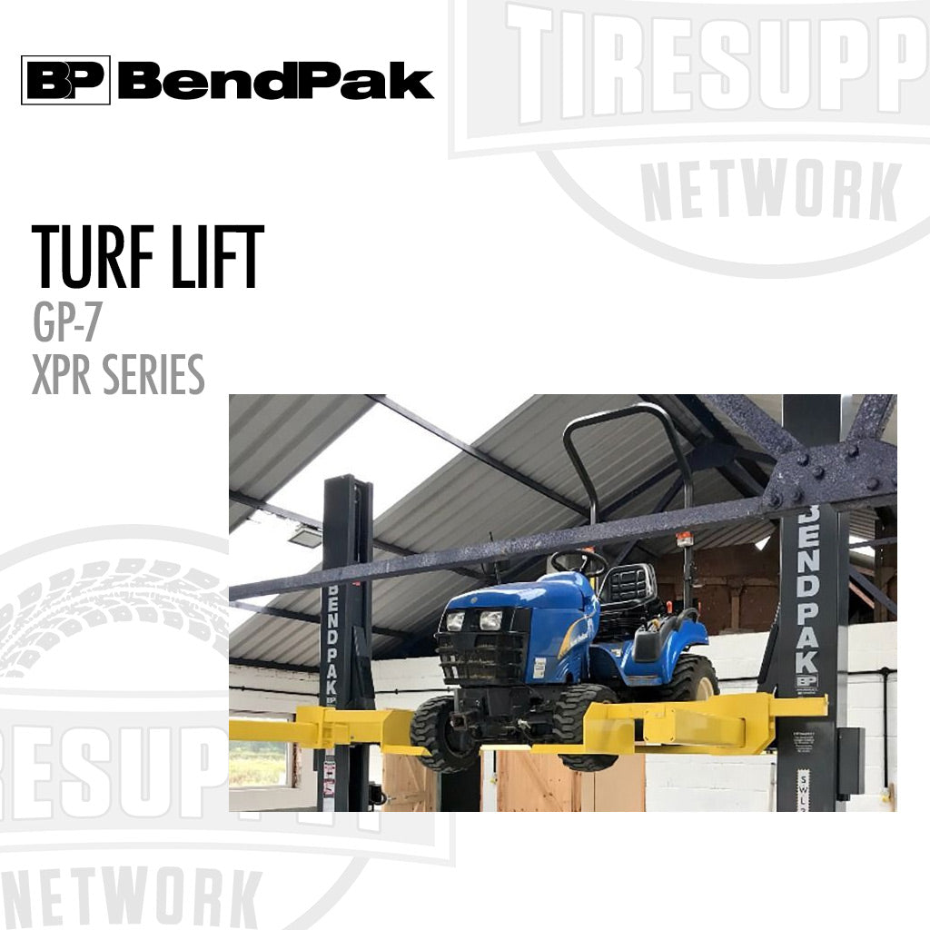 BendPak Turf Lift GP-7 XPR Series lifting a blue tractor in a warehouse.