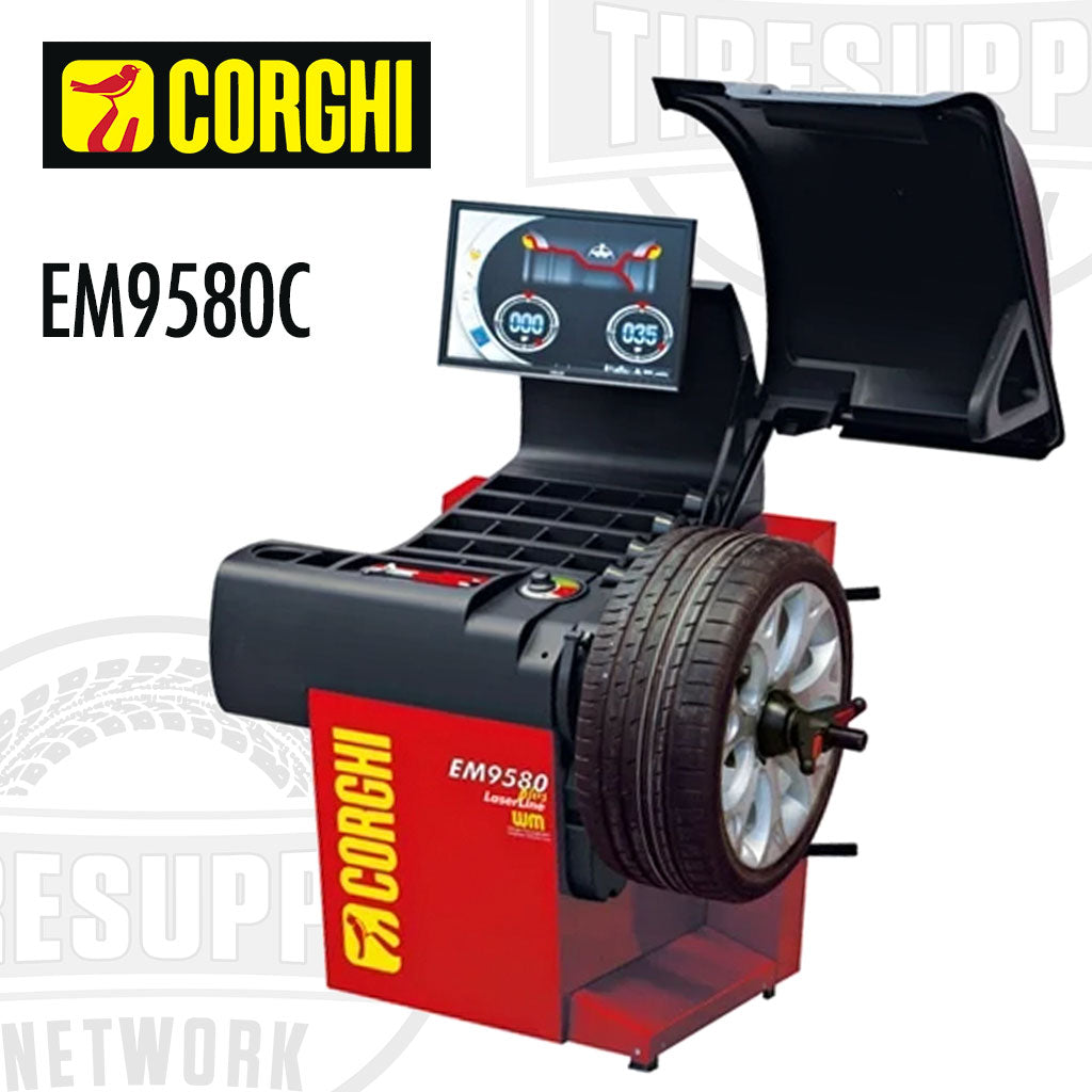 A red and black Corghi wheel balancer with touchscreen monitor, model EM9580C, balancing a tire.