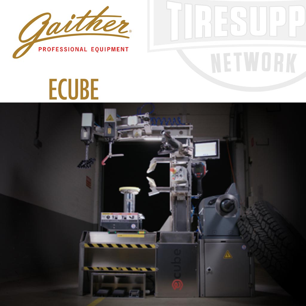 A commercial Gaither tire changer machine, the ECUBE, set up indoors, showcasing its design and equipment layout with a focus on tire changing and balancing functionality.