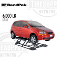 Red car on a BP BendPak tire lifting device with '6,000 LB' and 'LR-60' text.