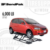 Red car on a BP BendPak tire lifting device with '6,000 LB' and 'LR-60' text.