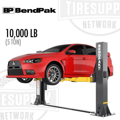 A red car lifted on a BendPak 2-Post Lift with a capacity of 10,000 lbs (5 tons). The lift is black and yellow, and it's shown in an advertisement context.