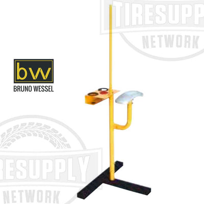 A Bruno Wessel K-5 Tire Studding Station stand in yellow and black color with a mount, support arm, holster, and cup for the studding process.