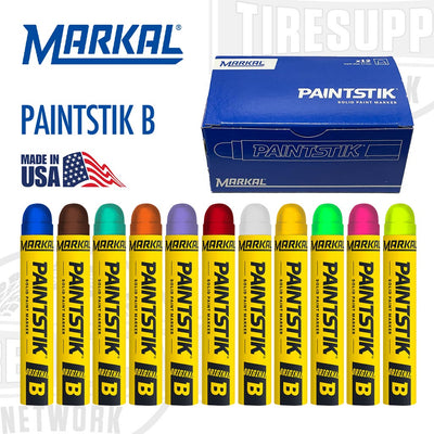 A collection of Markal Paintstik solid paint markers in various colors displayed in front of a box labeled PAINTSTIK B. Markal Paintstick. Solid paint marker. Industrial marking paint. Tire marking paint. MADE IN USA